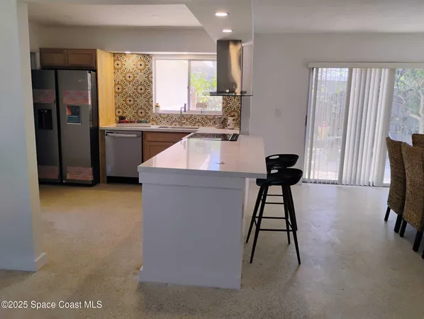 a view of kitchen with furniture and large window