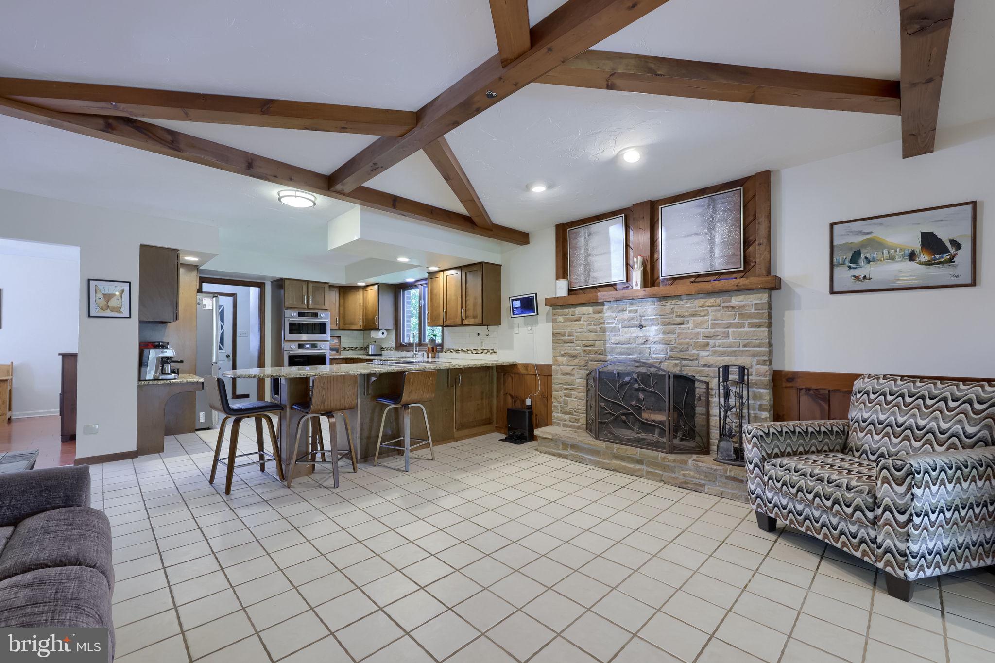 2211 Rocky Ridge Court York, PA 17406 - Photo 16 of 48 a living room with furniture a fireplace and kitchen view