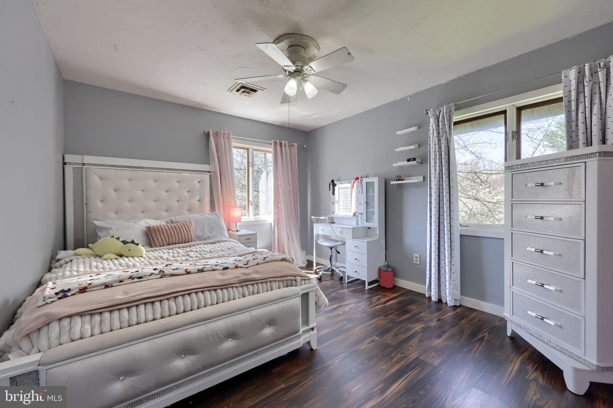 2211 Rocky Ridge Court York, PA 17406 - Photo 30 of 48 a bedroom with a large bed and a chandelier