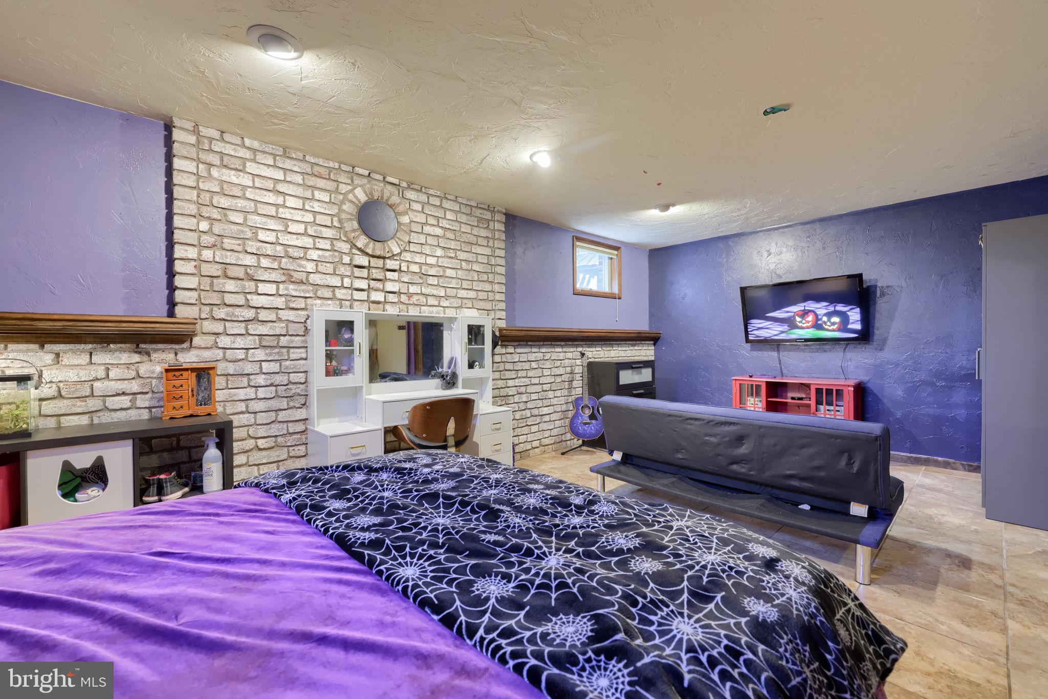 2211 Rocky Ridge Court York, PA 17406 - Photo 35 of 48 a spacious bedroom with a bed and a fireplace