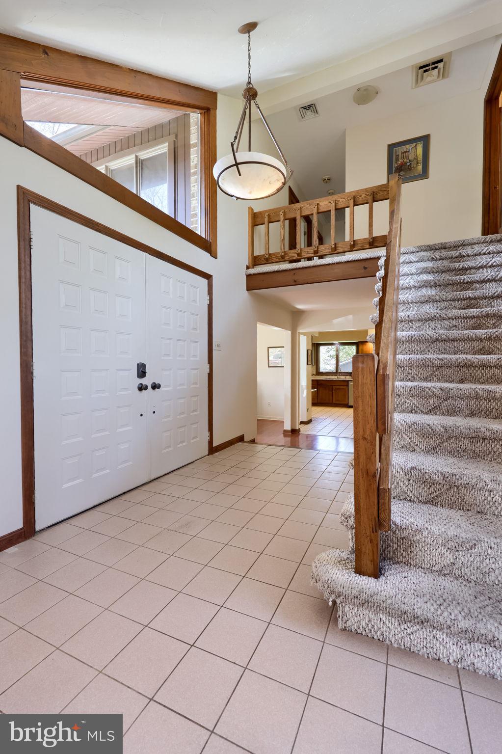 2211 Rocky Ridge Court York, PA 17406 - Photo 4 of 48 a view of a hallway with wooden floors and couches