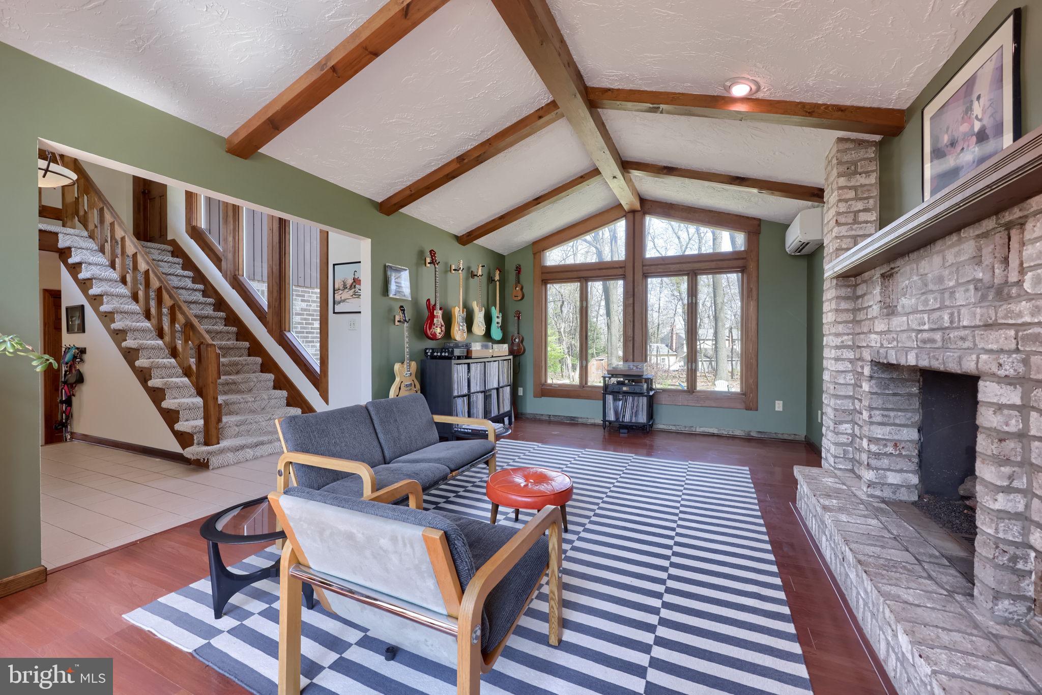 2211 Rocky Ridge Court York, PA 17406 - Photo 6 of 48 a living room with furniture a fireplace and a floor to ceiling window