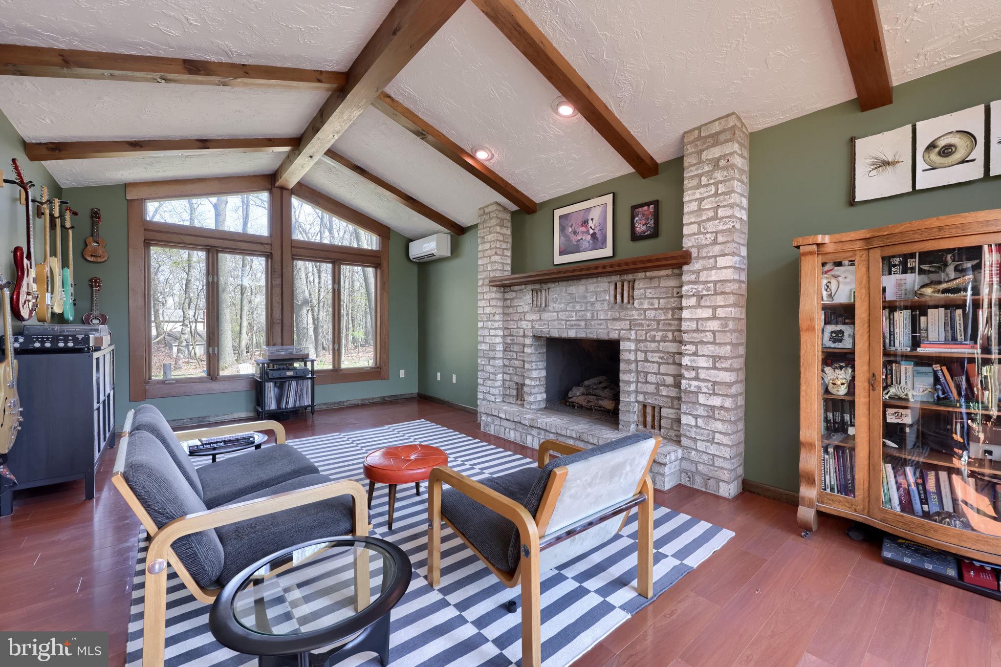 2211 Rocky Ridge Court York, PA 17406 - Photo 7 of 48 a living room with furniture a bookshelf and a fireplace