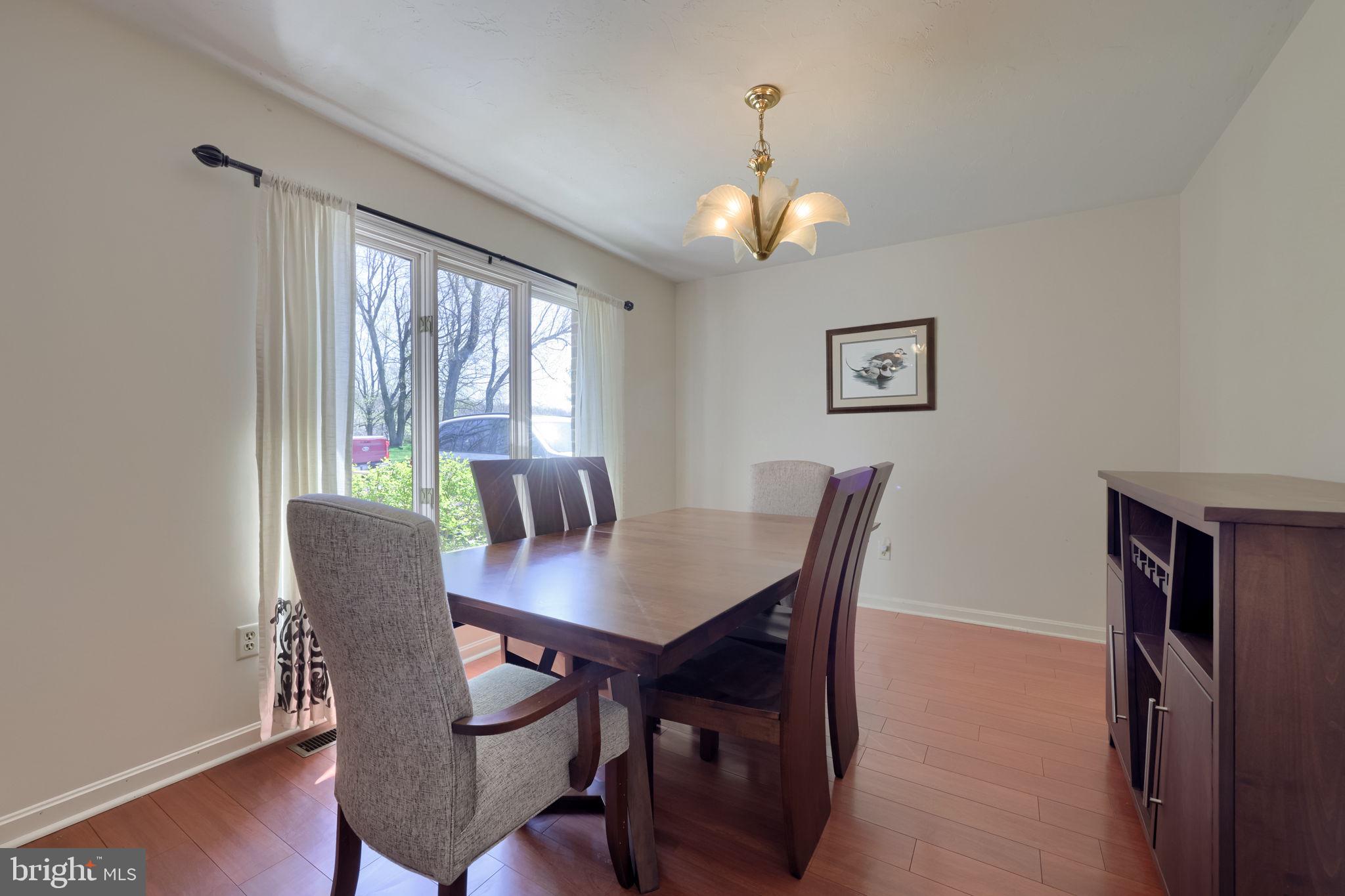 2211 Rocky Ridge Court York, PA 17406 - Photo 10 of 48 a view of a dining room with furniture wooden floor and a chandelier