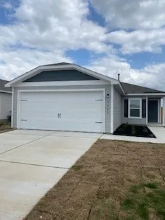 a front view of a house with garage