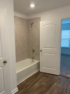 a bathroom with a bathtub and a shower