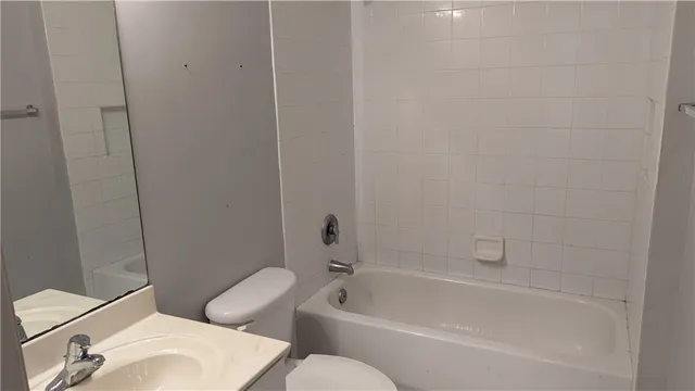 a white bath tub sitting next to a white toilet