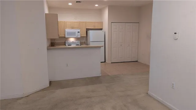 a view of a kitchen with a sink and cabinets