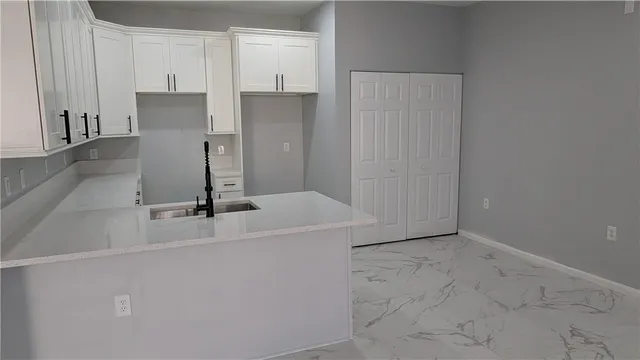 a kitchen with a sink and refrigerator