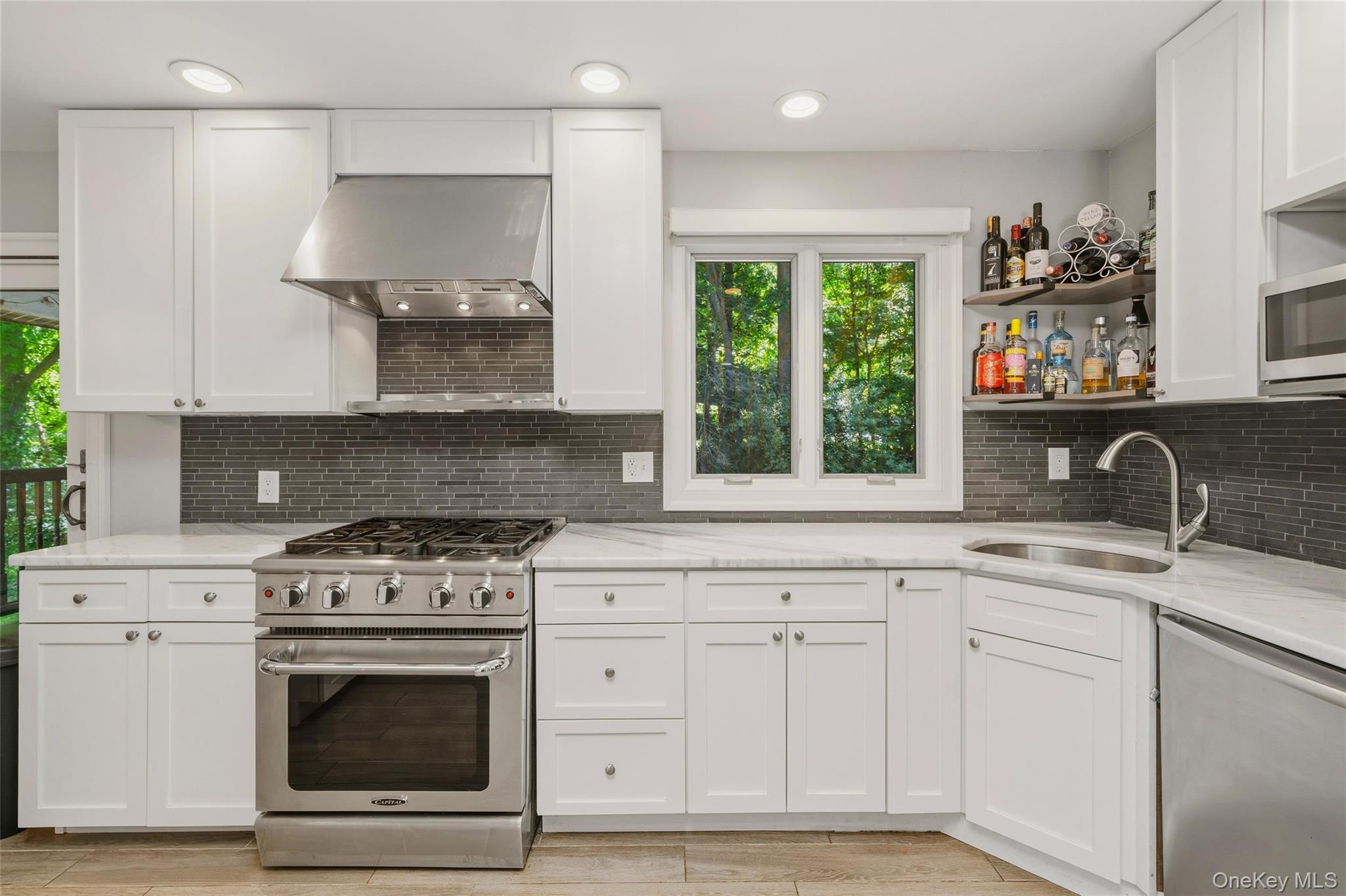 44 Sayer Road Blooming Grove, NY 10914 - Photo 10 of 39 a kitchen with granite countertop white cabinets and a stove with wooden floors