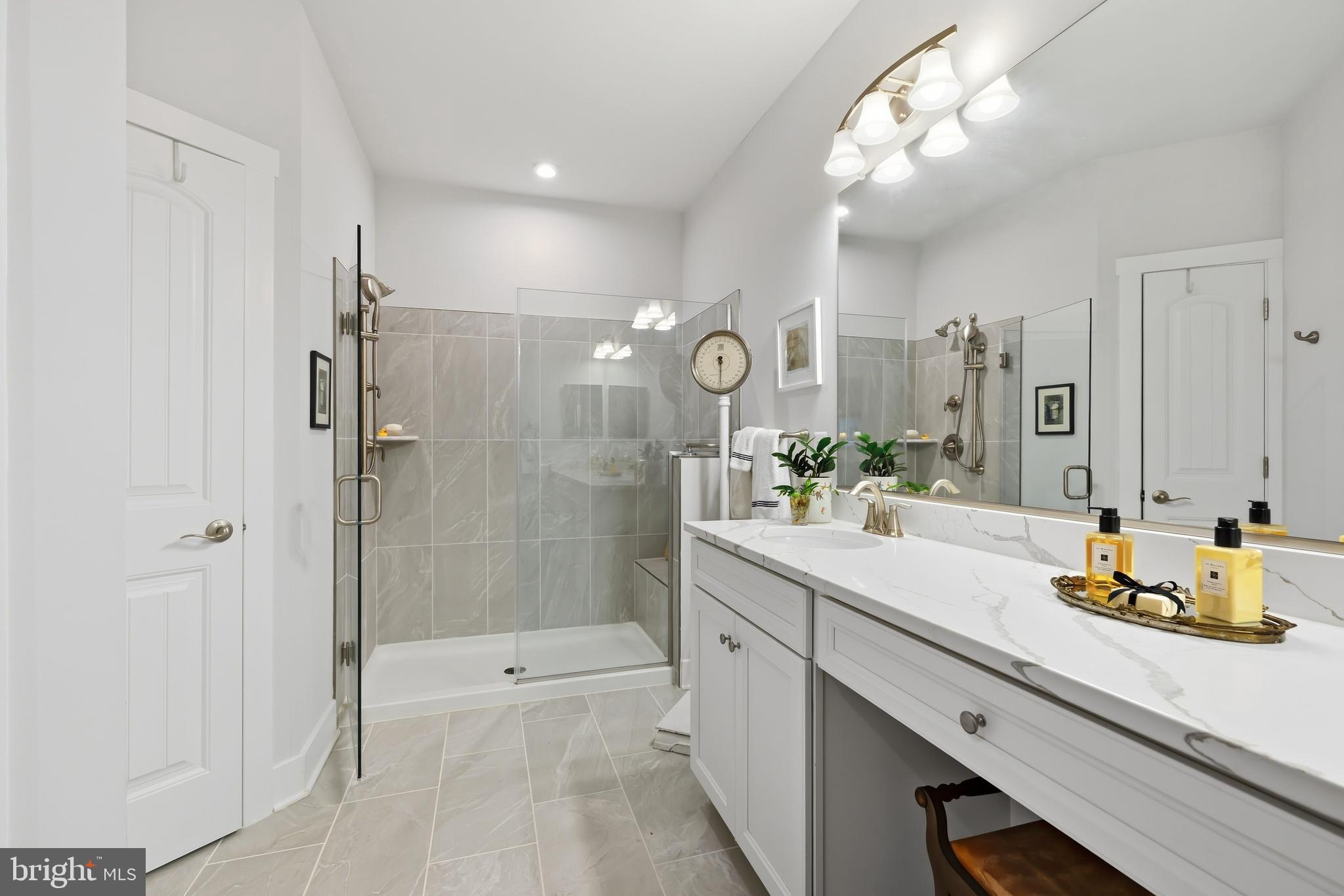 190 Harrier Way, Unit 24 Chester, MD 21619 - Photo 42 of 78 a bathroom with a double vanity sink toilet and shower