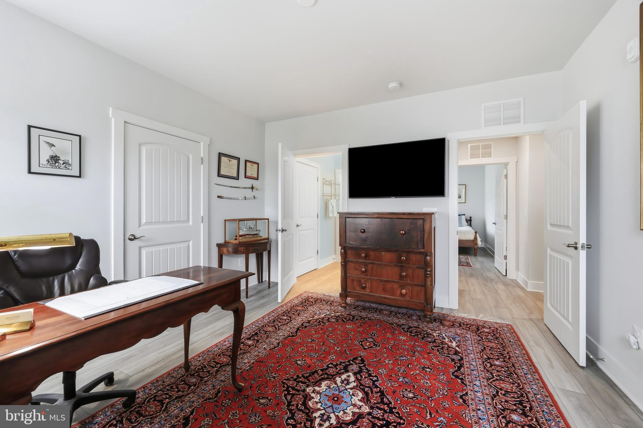 190 Harrier Way, Unit 24 Chester, MD 21619 - Photo 50 of 78 a living room with furniture a fireplace and a flat screen tv