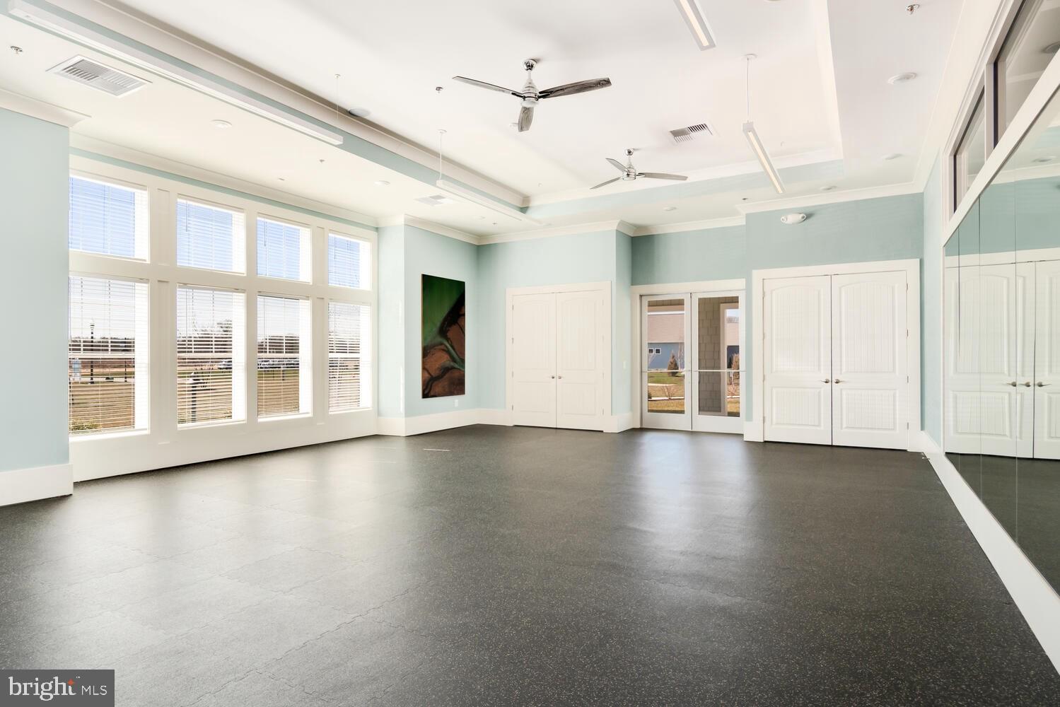 190 Harrier Way, Unit 24 Chester, MD 21619 - Photo 62 of 78 an empty room with wooden floor and windows