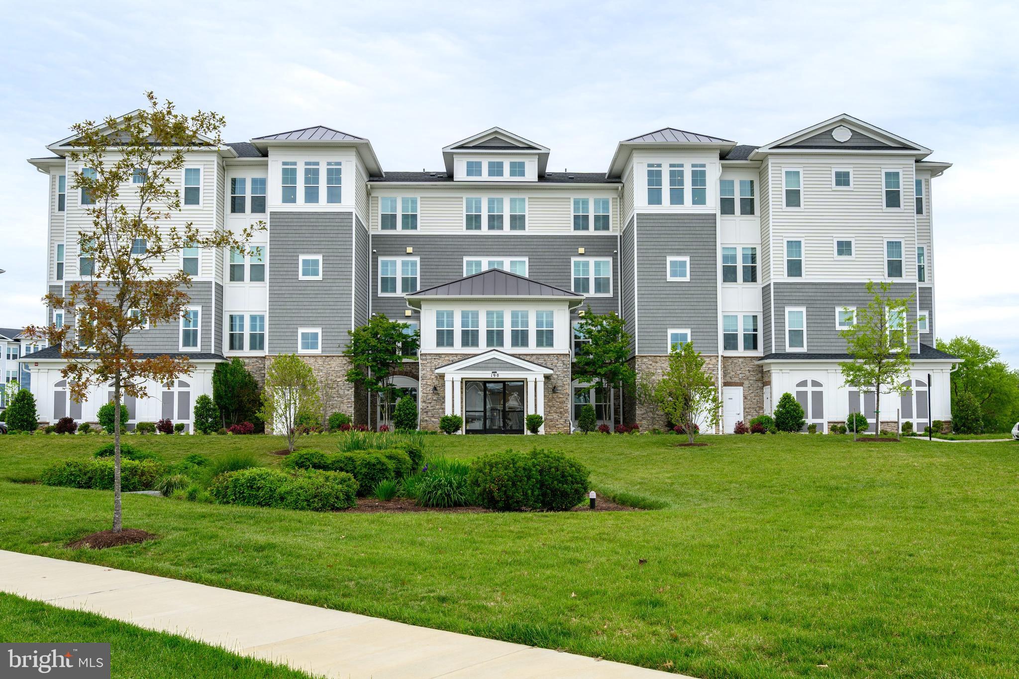 190 Harrier Way, Unit 24 Chester, MD 21619 - Photo 7 of 78 a front view of a residential apartment building with a yard