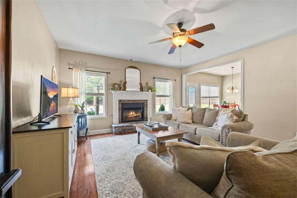 42 Pintail Lane Jefferson, GA 30549 - Photo 10 of 42 a living room with furniture a fireplace and a flat screen tv