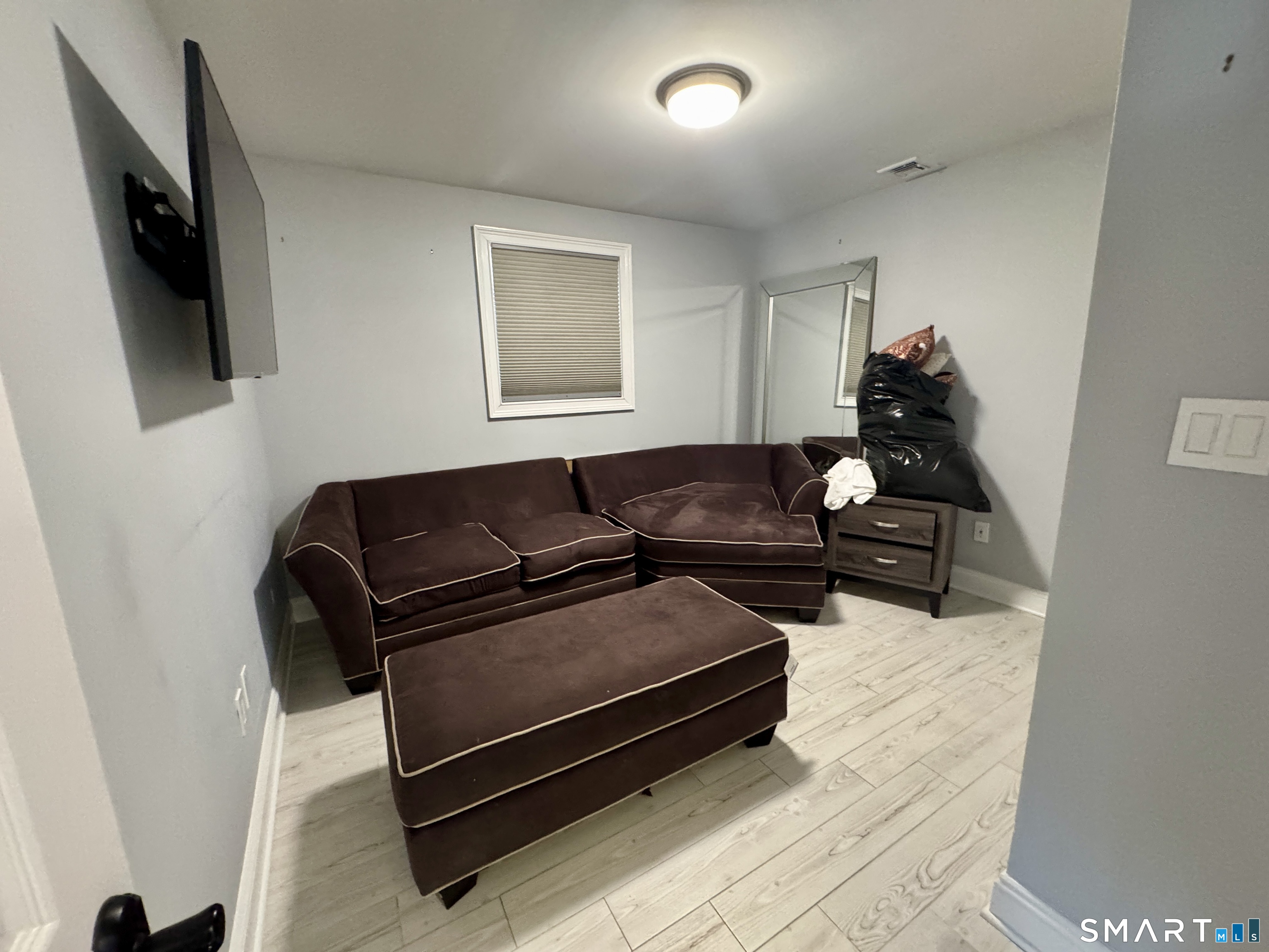 4 Hellstrom Road East Haven, CT 06512 - Photo 14 of 26 a living room with furniture a flat screen tv and a window