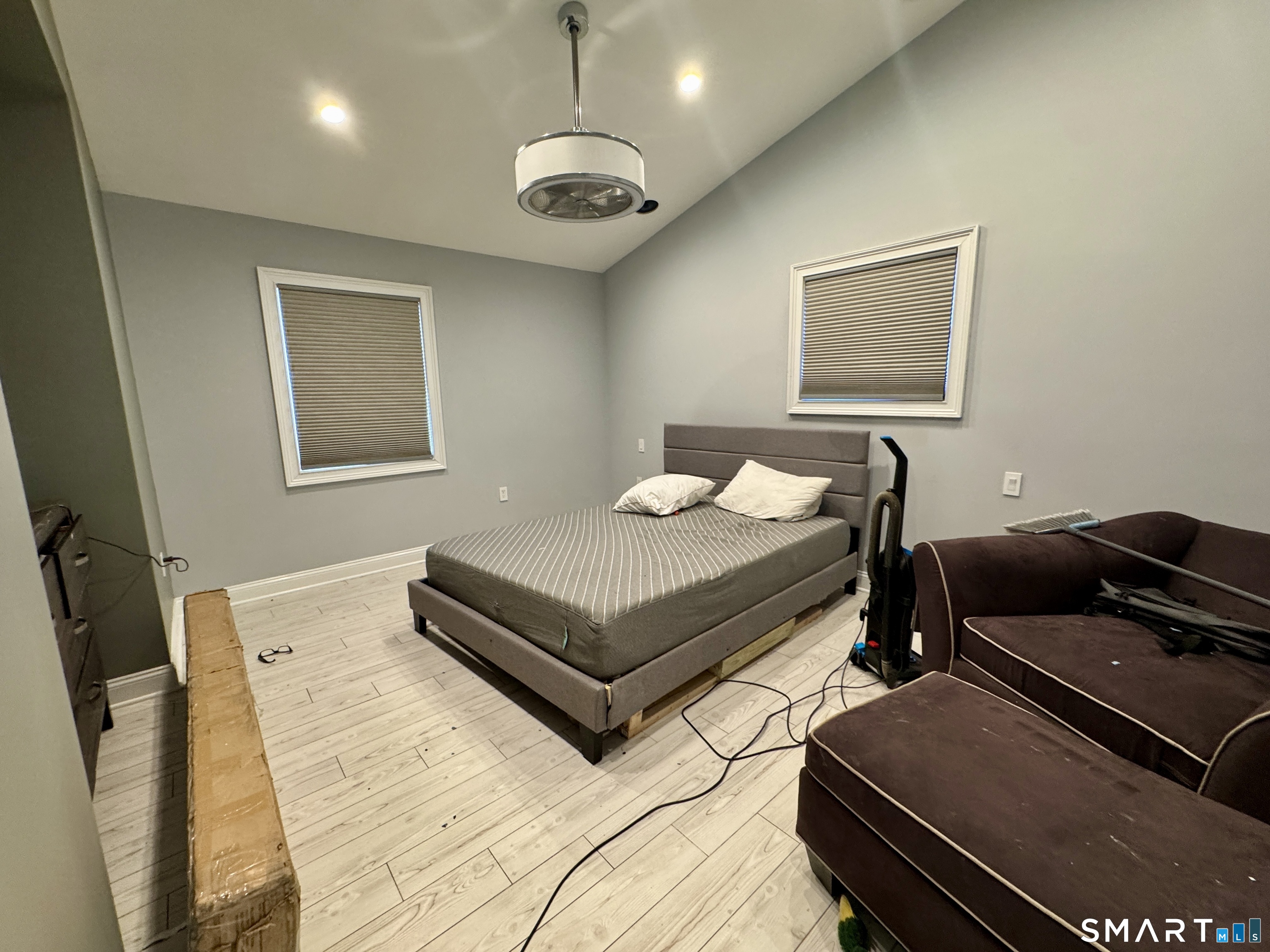 4 Hellstrom Road East Haven, CT 06512 - Photo 17 of 26 a bedroom with a bed and a chandelier