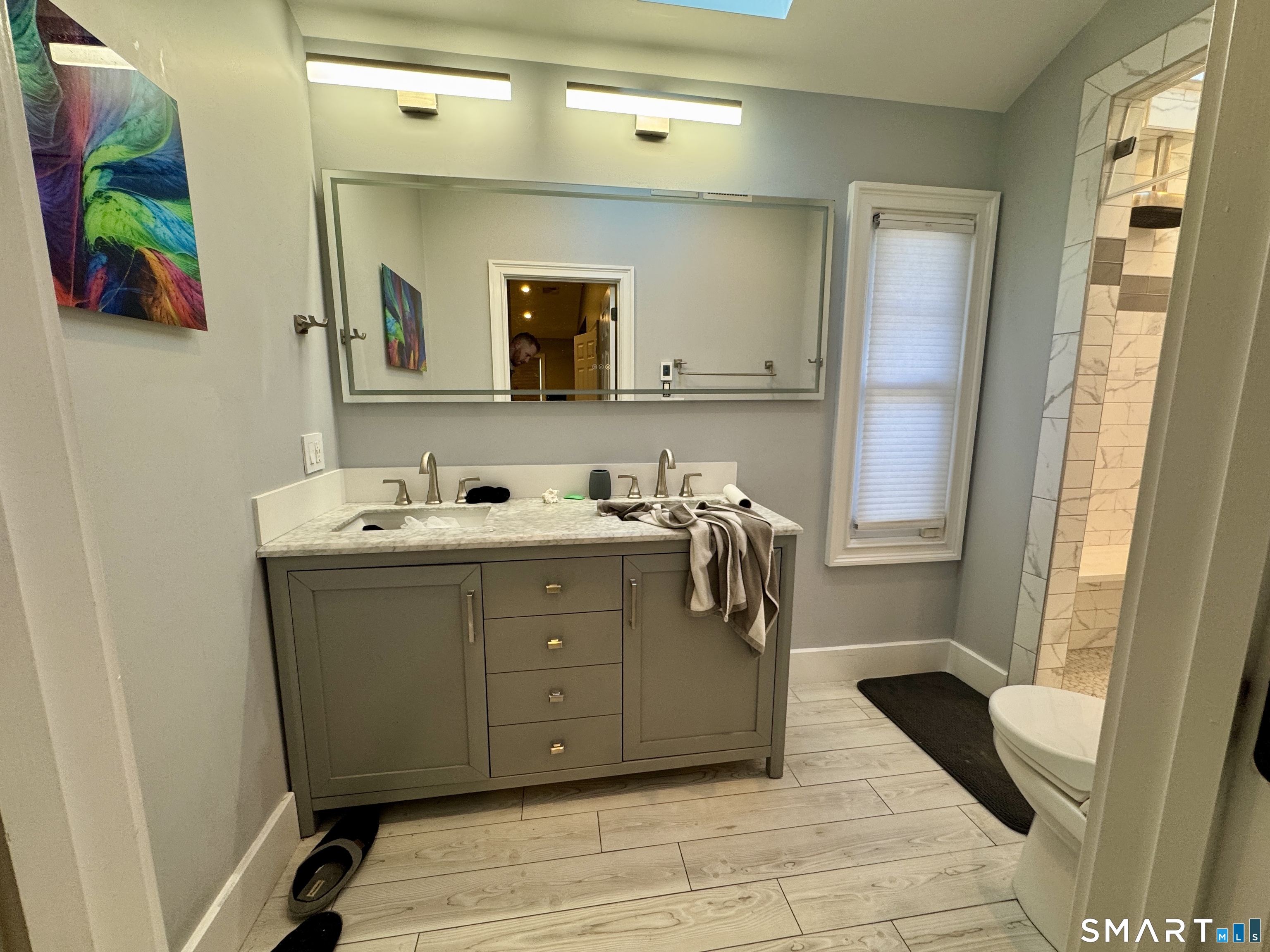 4 Hellstrom Road East Haven, CT 06512 - Photo 20 of 26 a bathroom with a sink vanity and mirror