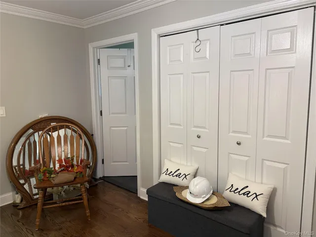 an entryway with wooden floor and cabinet