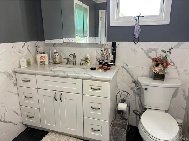 a bathroom with a sink toilet and mirror