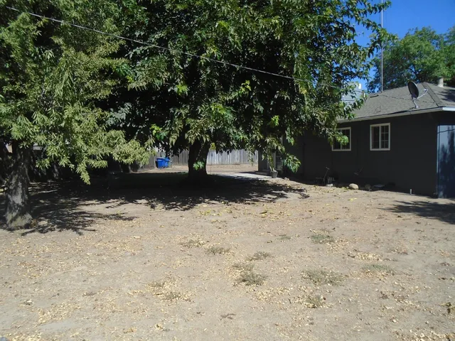 a front view of house with yard and trees