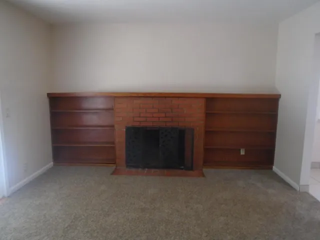 a view of an empty room and fire place