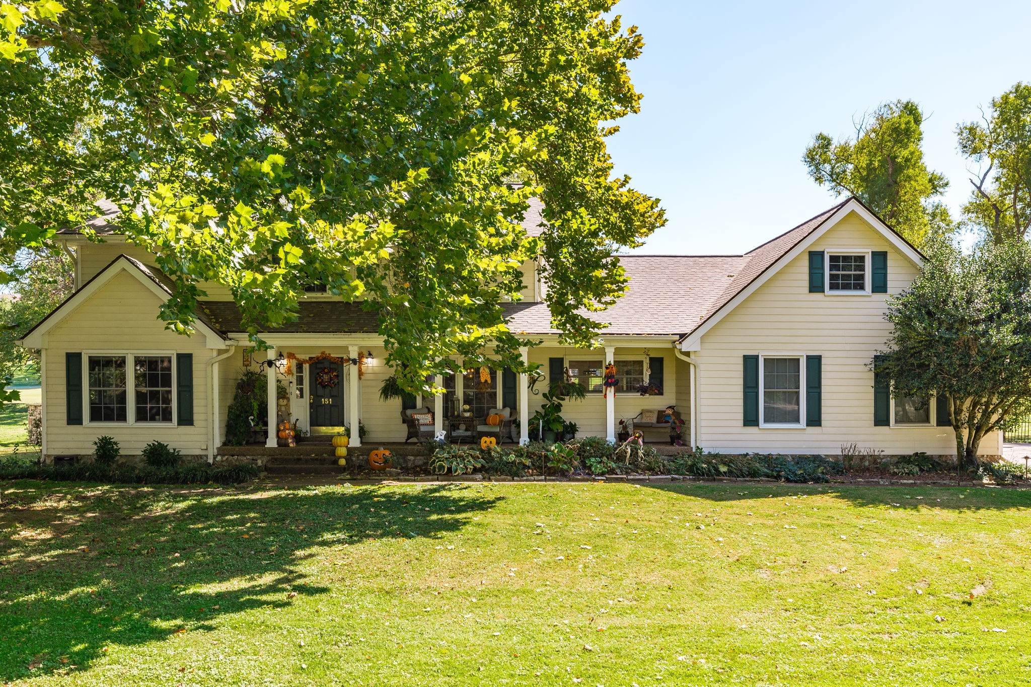 a front view of house with yard and trees