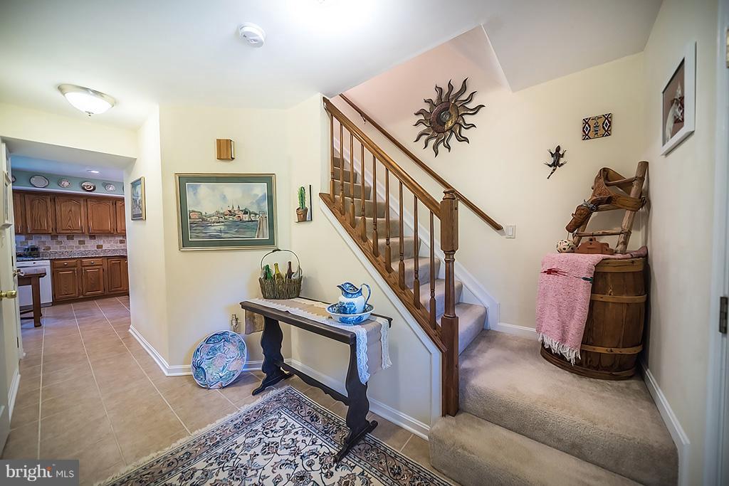 216 Serene Road Friendship, MD 20758 - Photo 11 of 29 a living room with furniture and stairs