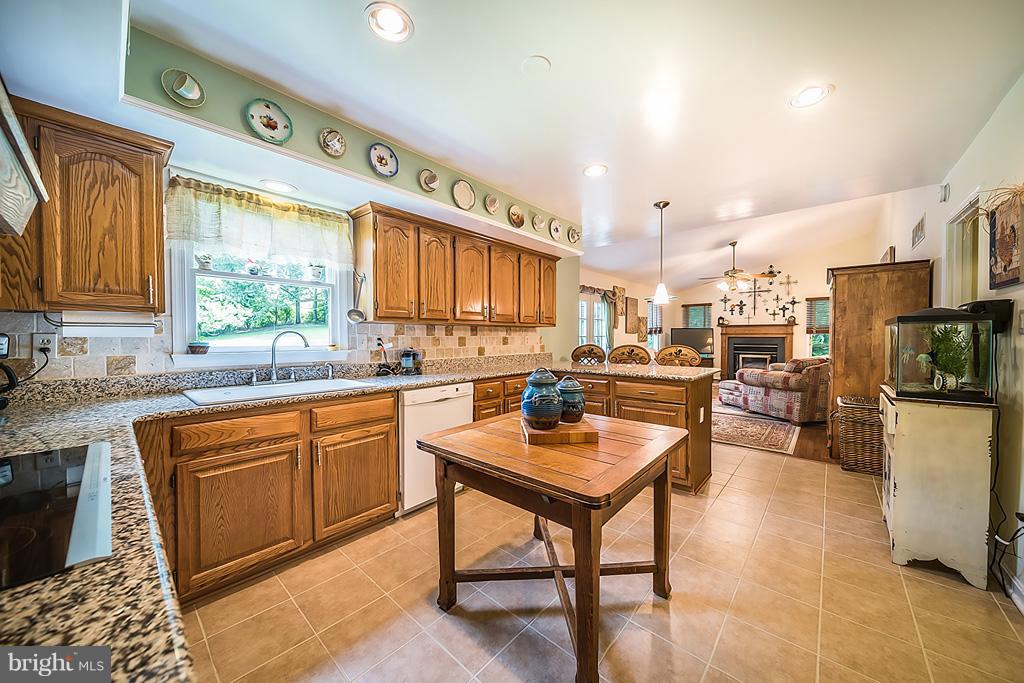 216 Serene Road Friendship, MD 20758 - Photo 15 of 29 a kitchen with stainless steel appliances granite countertop a sink a stove and a refrigerator