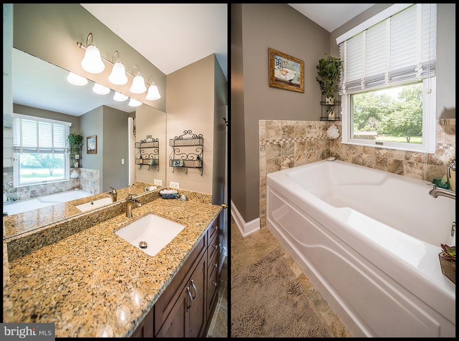216 Serene Road Friendship, MD 20758 - Photo 21 of 29 a bathroom with a granite countertop tub sink and mirror