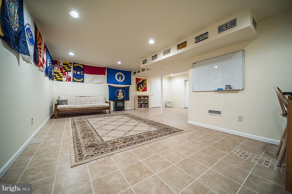 216 Serene Road Friendship, MD 20758 - Photo 26 of 29 a living room with a couch and a rug