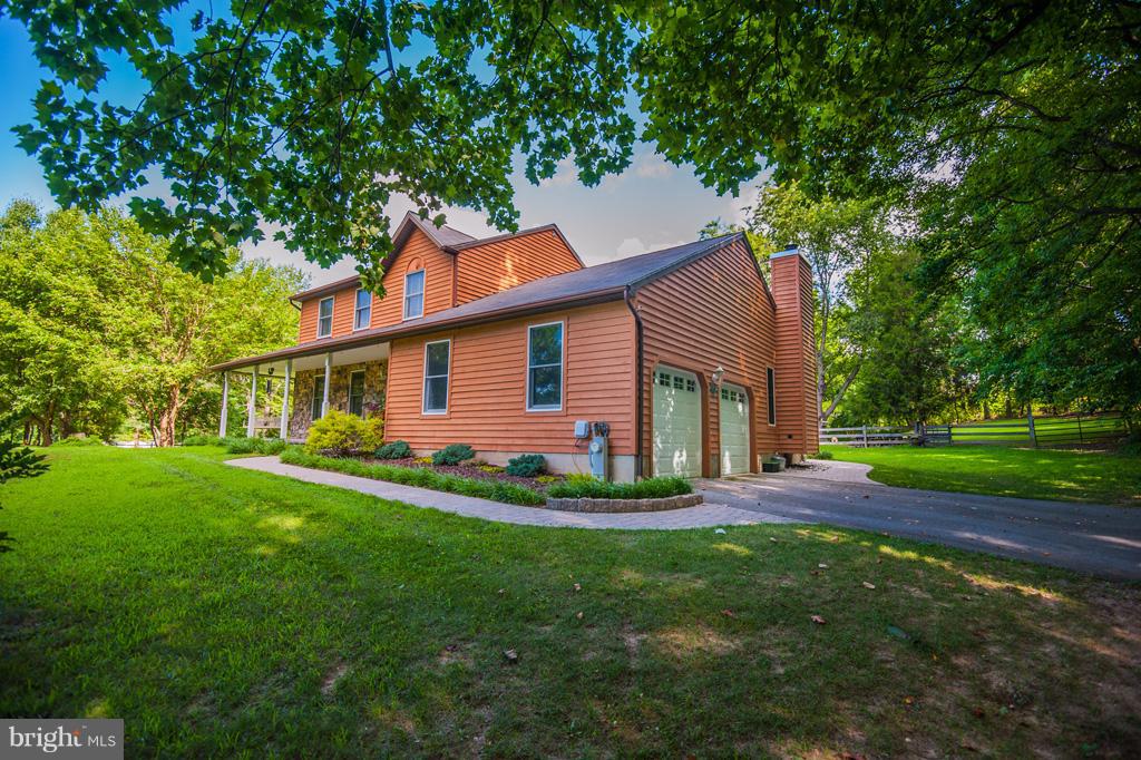 216 Serene Road Friendship, MD 20758 - Photo 4 of 29 a front view of a house with a yard and trees