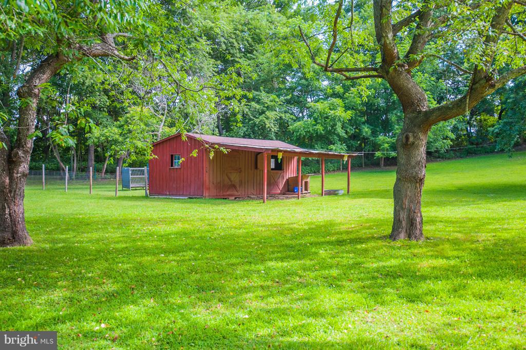 216 Serene Road Friendship, MD 20758 - Photo 8 of 29 a view of a backyard with a garden and large trees