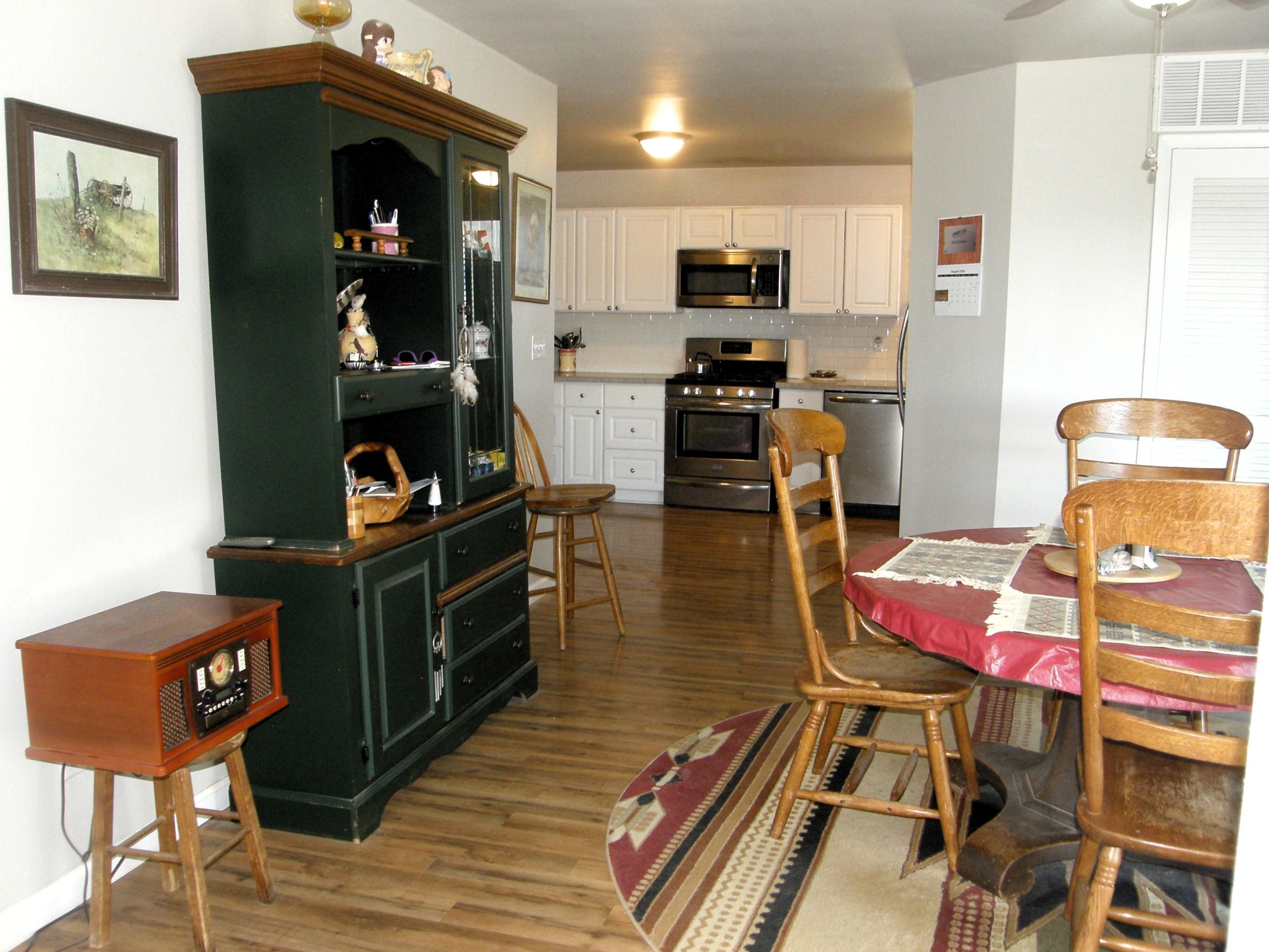 1163 16 Road Fruita, CO 81521 - Photo 15 of 42 a kitchen with stainless steel appliances kitchen island granite countertop a refrigerator and microwave