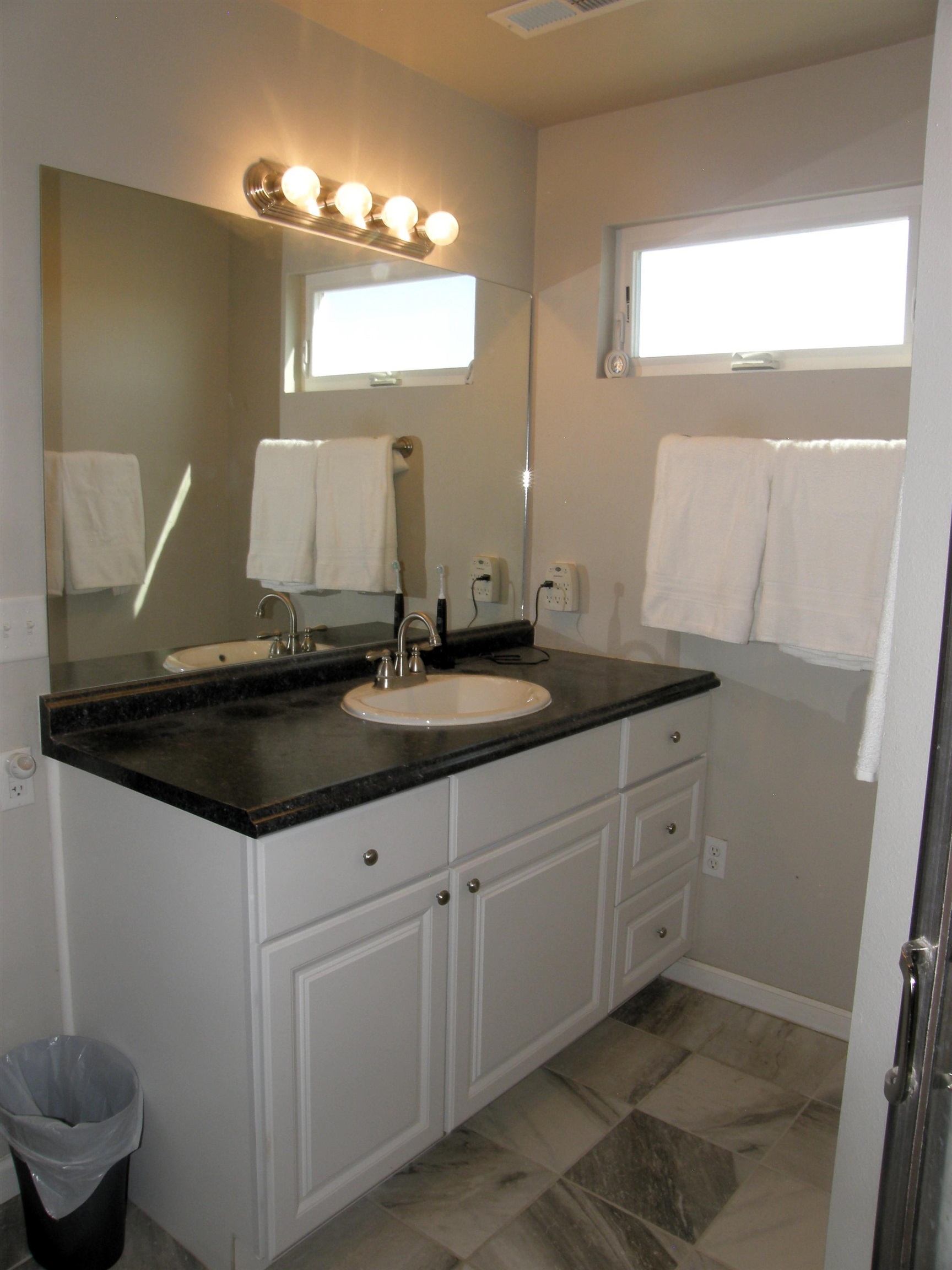 1163 16 Road Fruita, CO 81521 - Photo 24 of 42 a bathroom with a granite countertop sink a toilet and a mirror