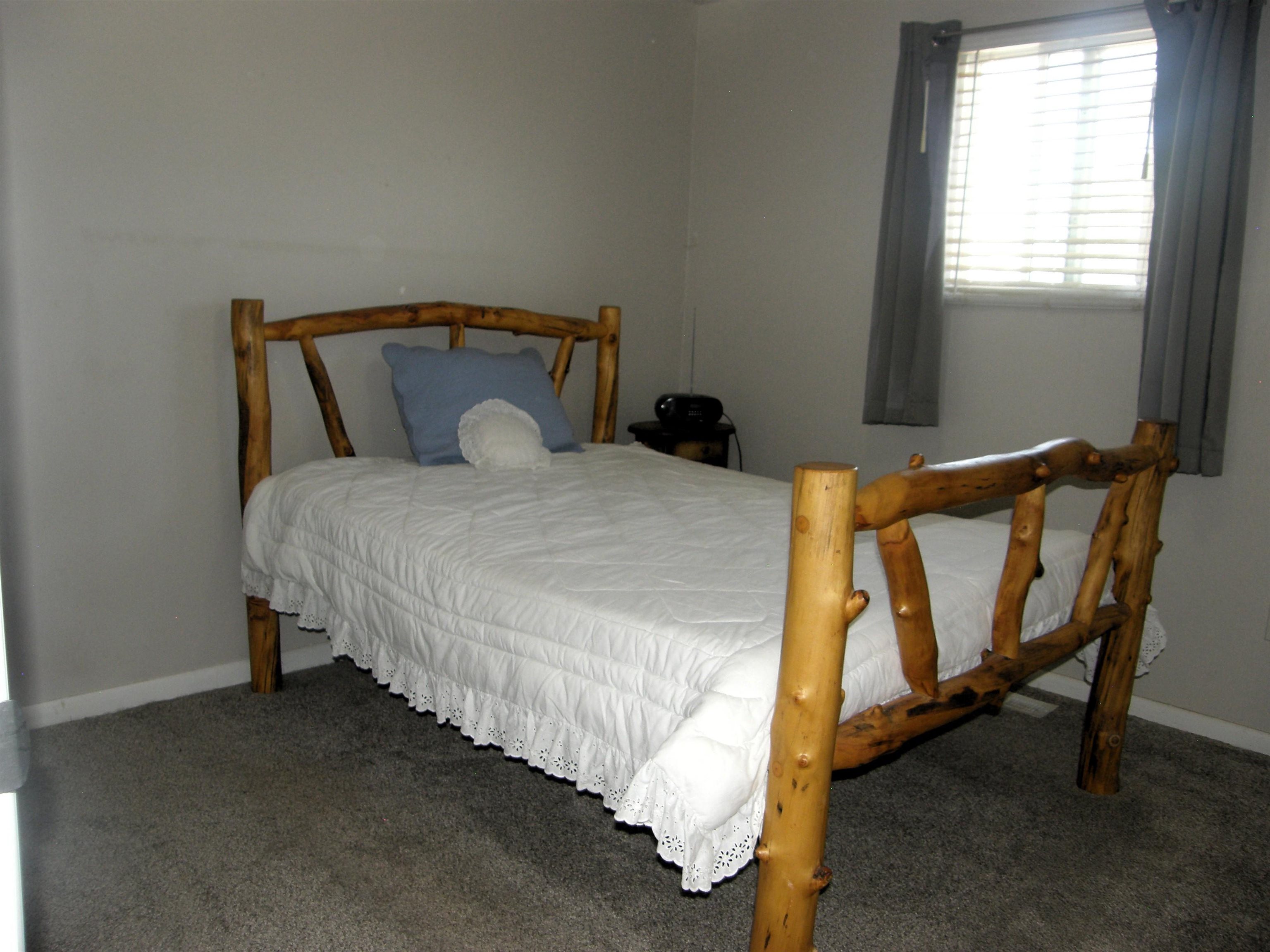 1163 16 Road Fruita, CO 81521 - Photo 26 of 42 a bed sitting in a bedroom next to a window