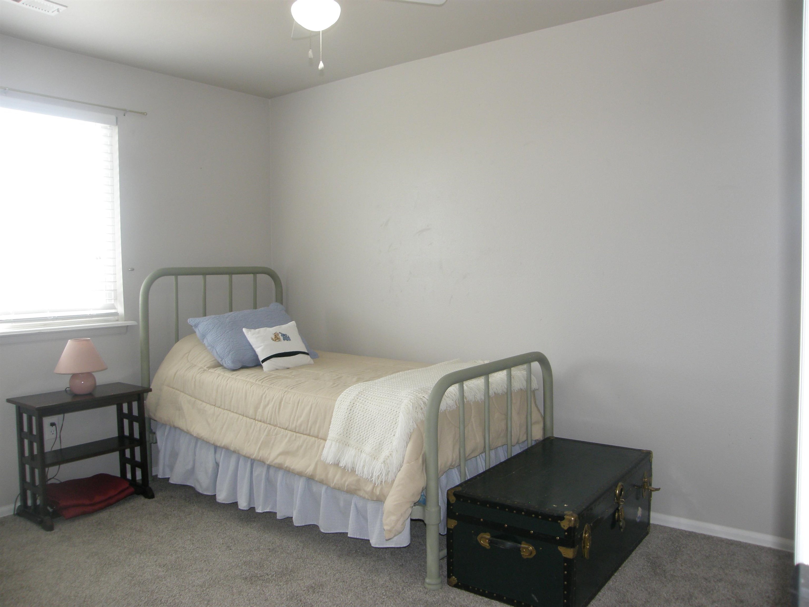 1163 16 Road Fruita, CO 81521 - Photo 31 of 42 a bedroom with a bed and a window