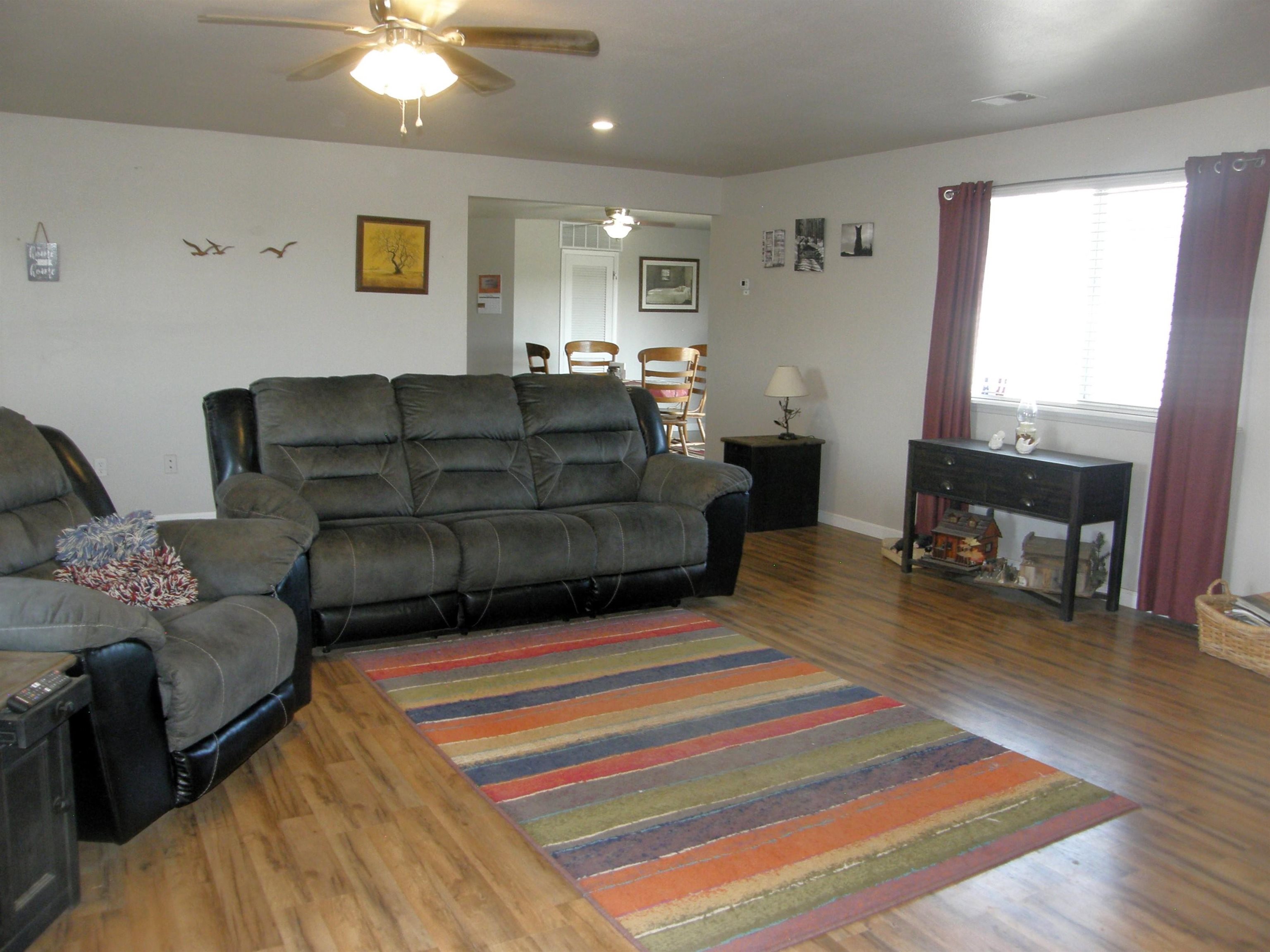 1163 16 Road Fruita, CO 81521 - Photo 10 of 42 a living room with furniture and a chandelier