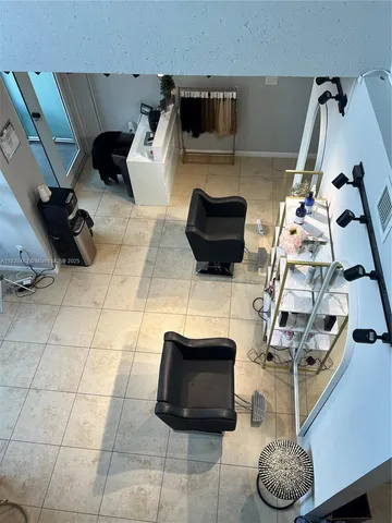 a living room with furniture a potted plant and a rug