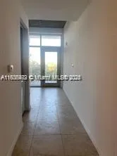 a view of a room with gym equipment and a window