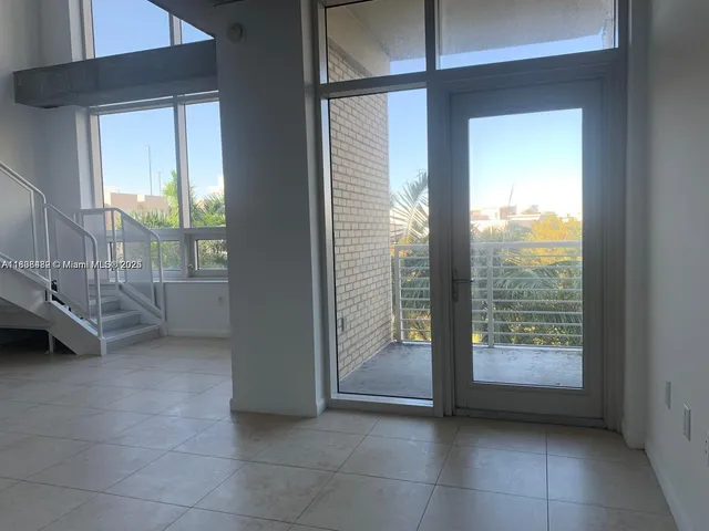 a view of an empty room and balcony