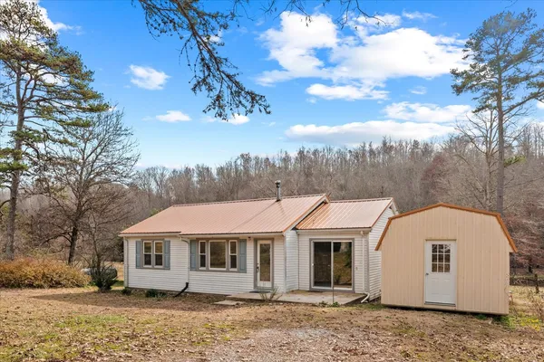 a view of a white house with a yard