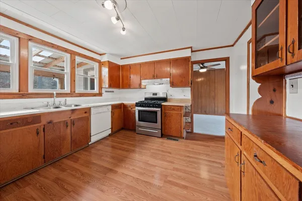 a kitchen with stainless steel appliances granite countertop a stove sink and cabinets