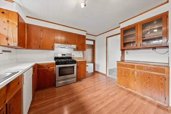 a kitchen with granite countertop wooden cabinets and stainless steel appliances