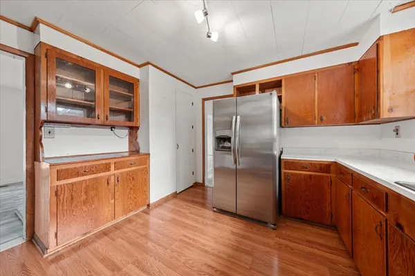 a kitchen with stainless steel appliances granite countertop a refrigerator and a sink