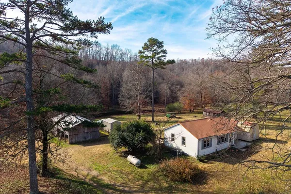 a aerial view of a house with a yard basket ball court and outdoor seating