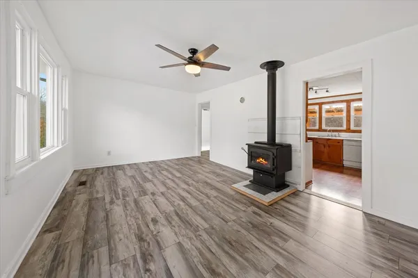 a living room with a bed furniture and a wooden floor
