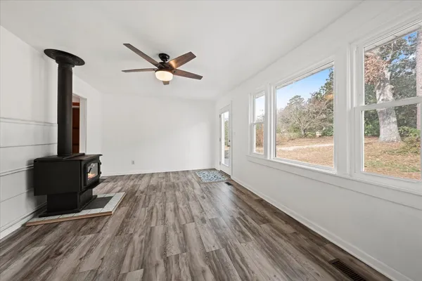 a view of a livingroom with wooden floor and a ceiling fan