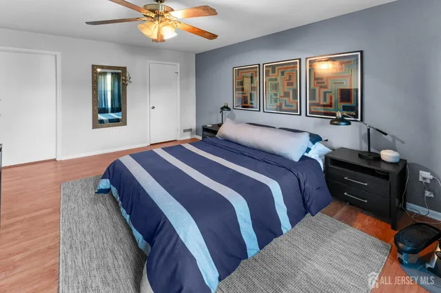 a bedroom with a bed and wooden floor