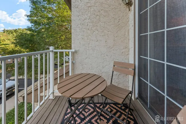 a view of a balcony with chair and wooden floor
